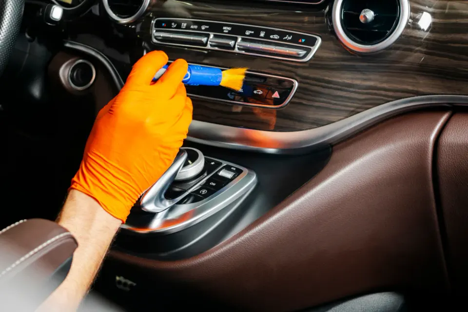 Professional car interior detailing tools and products used by mobile detailer